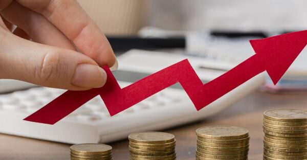 hand-holding-growth-arrow-with-coins-900x313